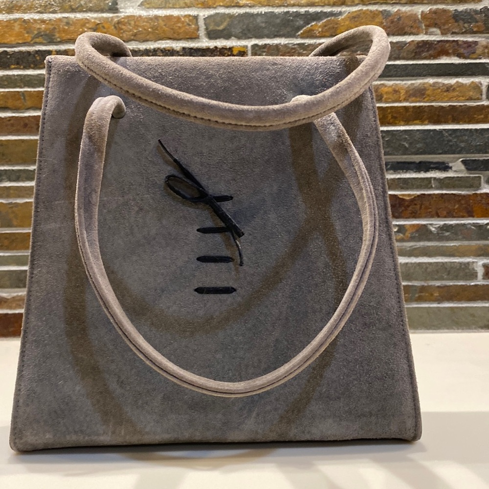 Vintage gray suede handbag with handles and black tie detail on front. Excellent